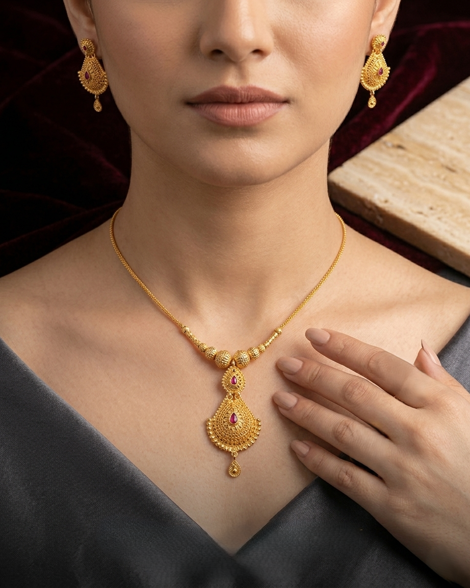 Tanishq Royal Crest Gold Necklace with Intricate Filigree Work and Central Ruby Stone
