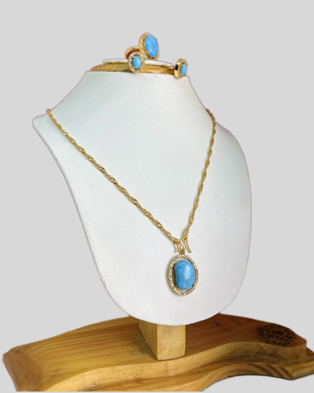 Gold necklace with a natural turquoise pendant.